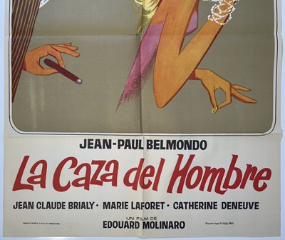 Lot 62 - JEAN PAUL BELMONDO - CAZA DEL HOMBRE / MALE HUNT (1964) - SPANISH ONE-SHEET POSTER.