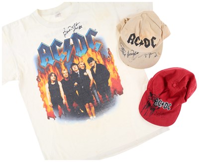 Lot 345 - AC/DC - SIGNED CAP AND T-SHIRTS.