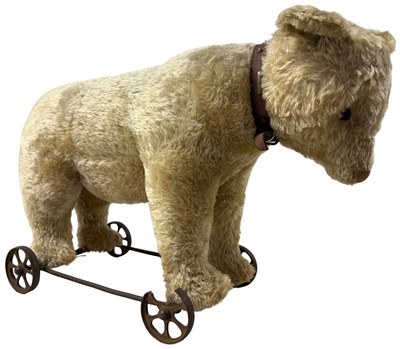 Lot 73 - A VINTAGE BEAR ON WHEELS
